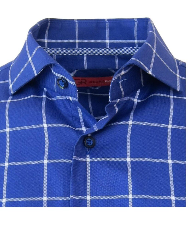 Classic with a twist best describes this handsome windowpane check in a vibrant cobalt blue. Detailed with a coordinating mini check inside the cuffs and inner collar stand piping.  The fabrication is rich and soft 100% pima cotton. Slight spread collar looks great under a jacket for business or on its own and roll the sleeves and go!
Machine wash, hang or lay flat to dry. Irons like a dream! 
Dry clean okay! 