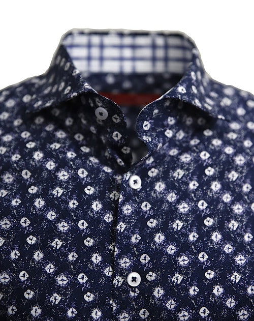 Known for our prints, this exclusive eye catching print is curated on our soft pima cotton. A stunning shade of indigo blue with white pattern is coordinated with a rich white, navy &amp; grey plaid inside the collar stand and cuffs. Looks terrific with the sleeves down or with the Georg Roth roll showing the handsome cuff detail.
100% Cotton
Machine wash cold hang to dry or dry clean 